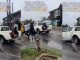 "When you are going to office and you don’t want to get wet" – Reaction as lady grabs onto a moving vehicle in an attempt to cross a flooded road (VIDEO)