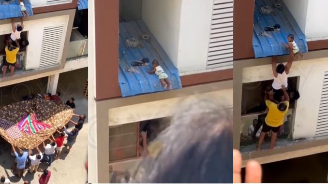 Baby decides to reunite community as the climbs to the roof of a story building (VIDEO)