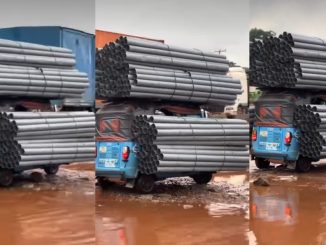 Keke rider struggles on damaged road after overloading his tricycle with aluminum rods (VIDEO)