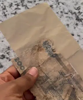 Newly wedded laments as she flaunts torn old N200 she saw in envelope as wedding gift 