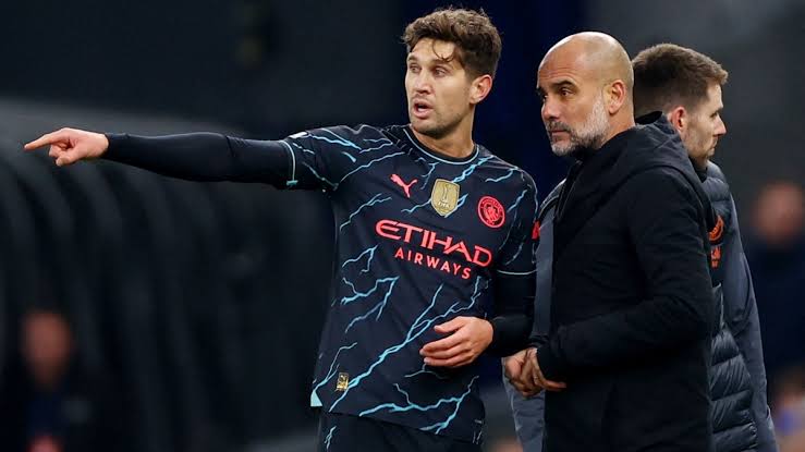 Pep Guardiola and John Stones