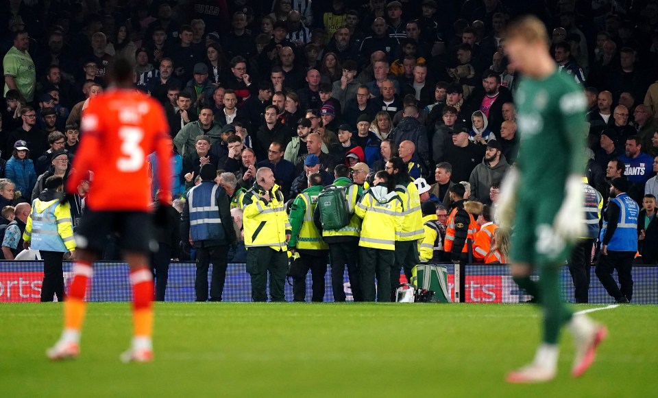 Medical staff attended to the fan in the away end