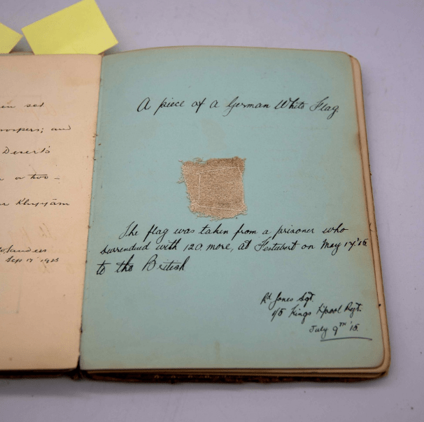 Another page of the album contains a fragment of white German surrender flag taken from Sgt Jones of the 1/5 Kings Liverpool Regiment