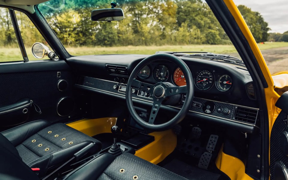 The car is finished in Egg Yolk paintwork over a black leather interior