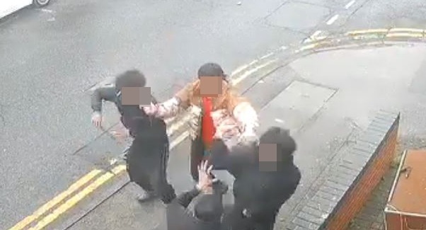 Two men are seen sprinting into the road to join the brawl