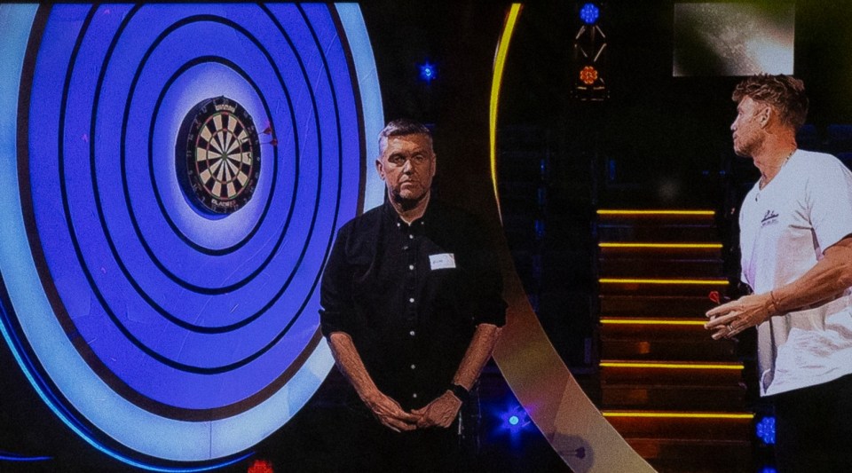 Freddie at the oche while being overseen by new scorer Richard Ashdown