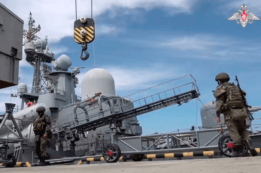 Russian military personnel load a cruise missile on board a warship during military drills with tactical nuclear weapons (file image)