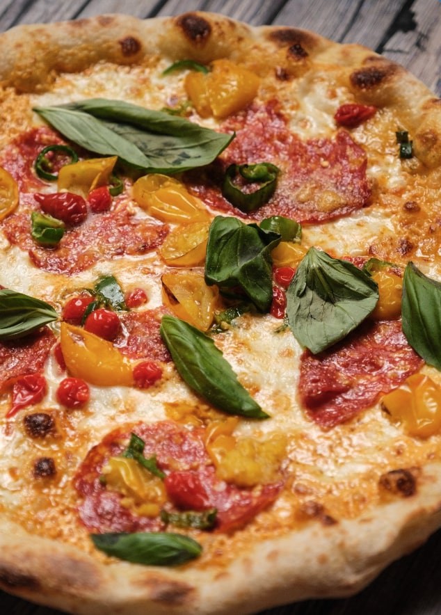 The Lorenzo pizza features mascarpone cream, fior di latte, Calabrian ventricina of simonini, parmesan, green chilli, roquito peppers, basil and piennolo tomatoes