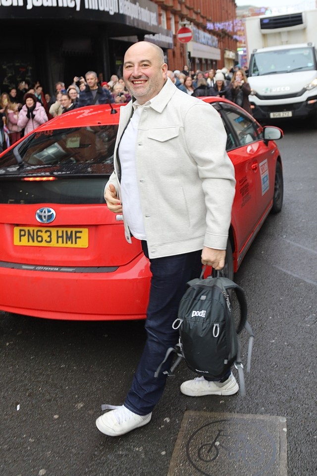 Wynne beamed as he arrived outside of the tower in a taxi