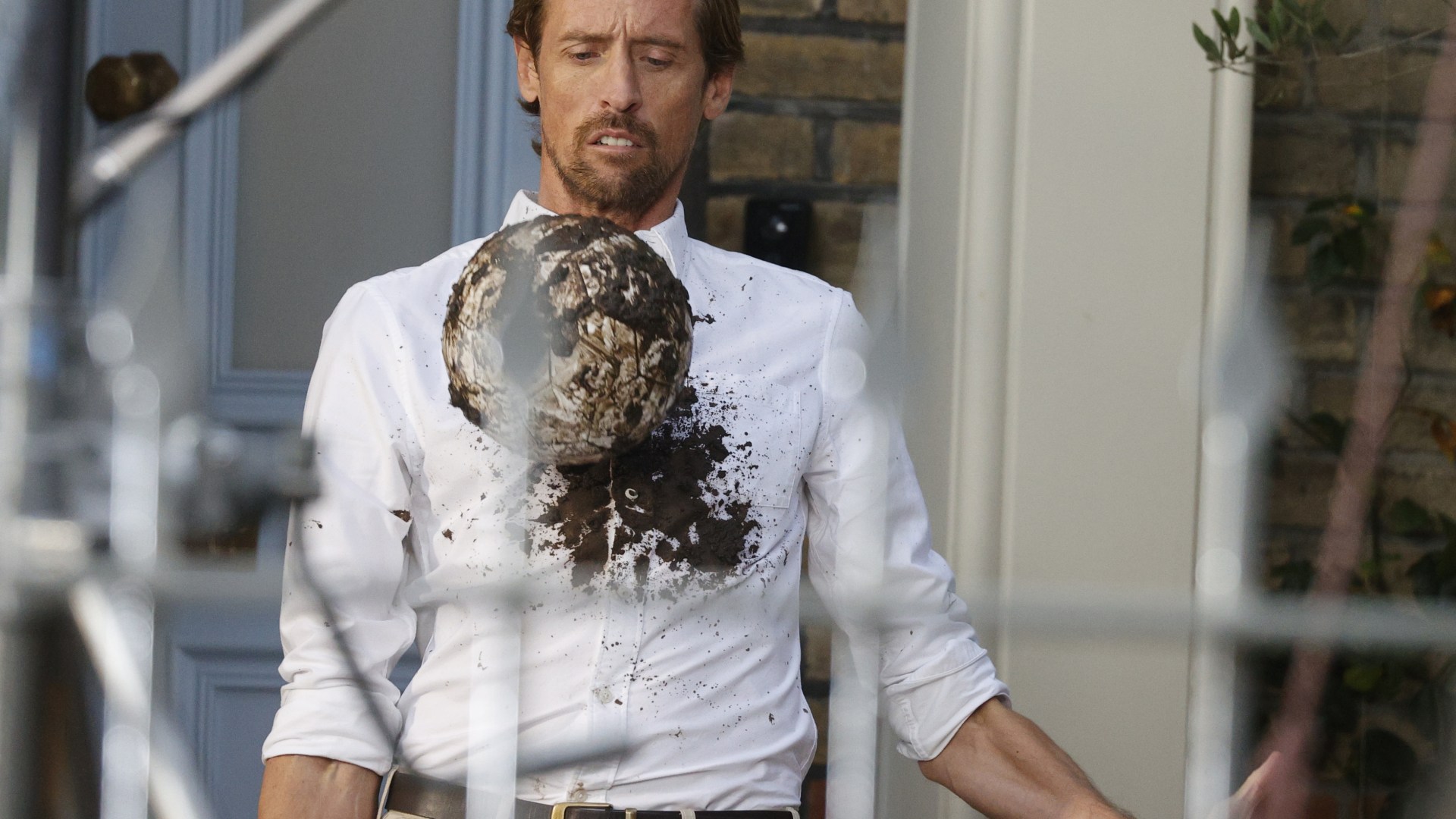 Peter Crouch gets white shirt covered in mud as he films TV ad for Ariel after signing six-figure deal