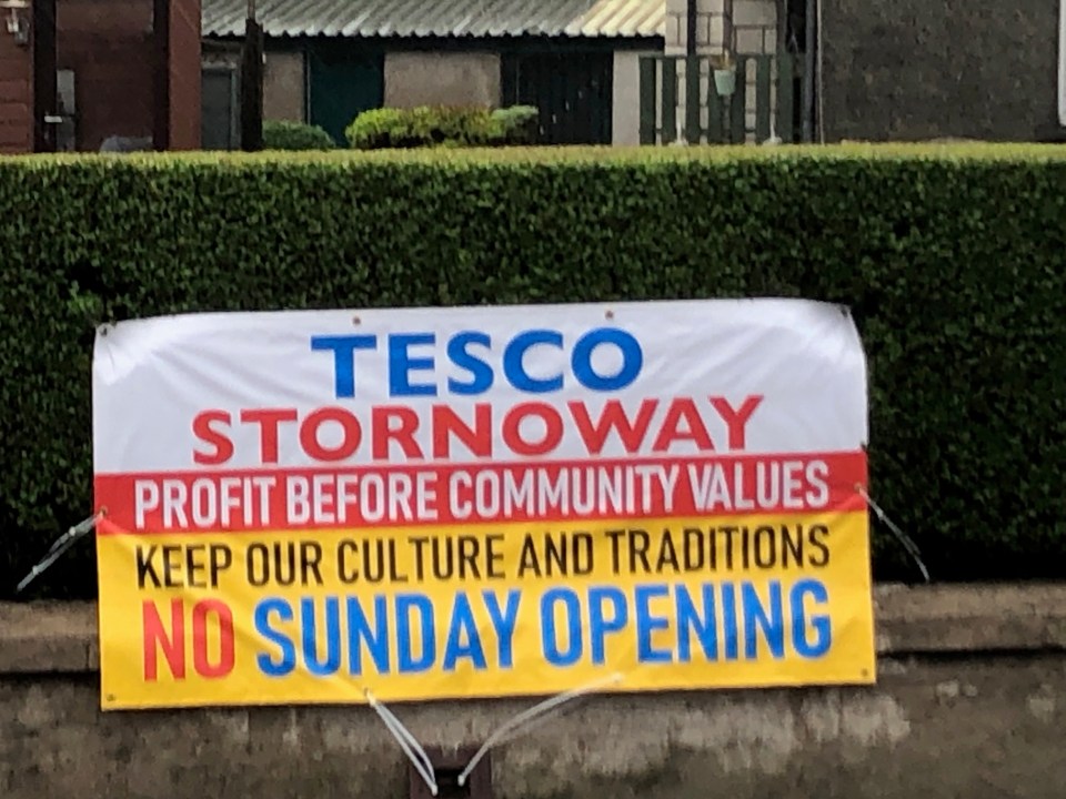 The banner slamed the supermarket giant.