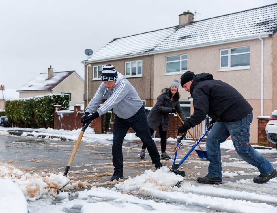 Neighbours brave the cold to sweep away snow