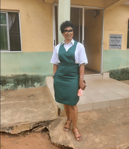 Woman dresses up in uniform as she attends her secondary school's 40th reunion