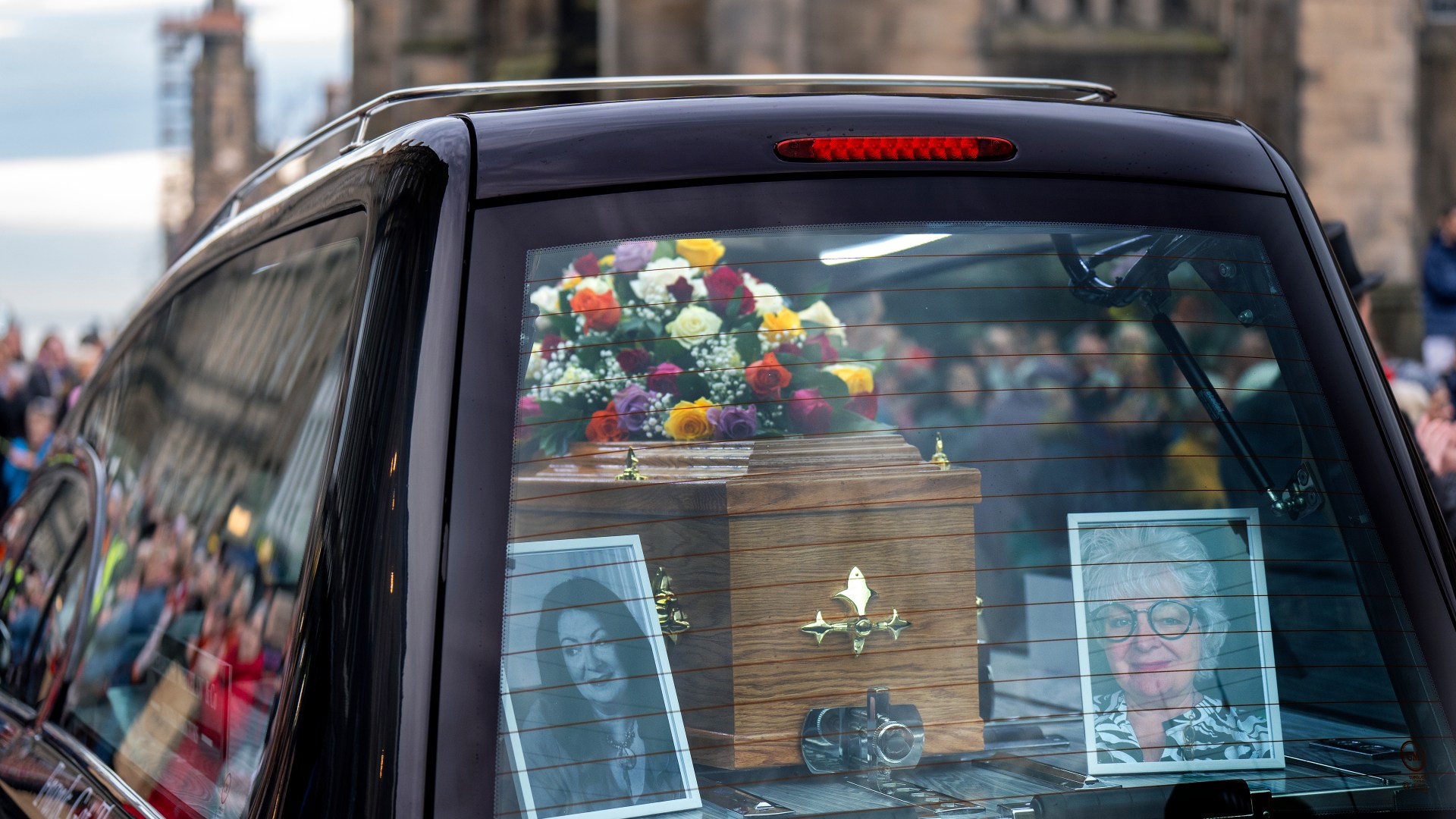 Janey Godley's famous catchphrase displayed on hearse as hundreds of fans line street