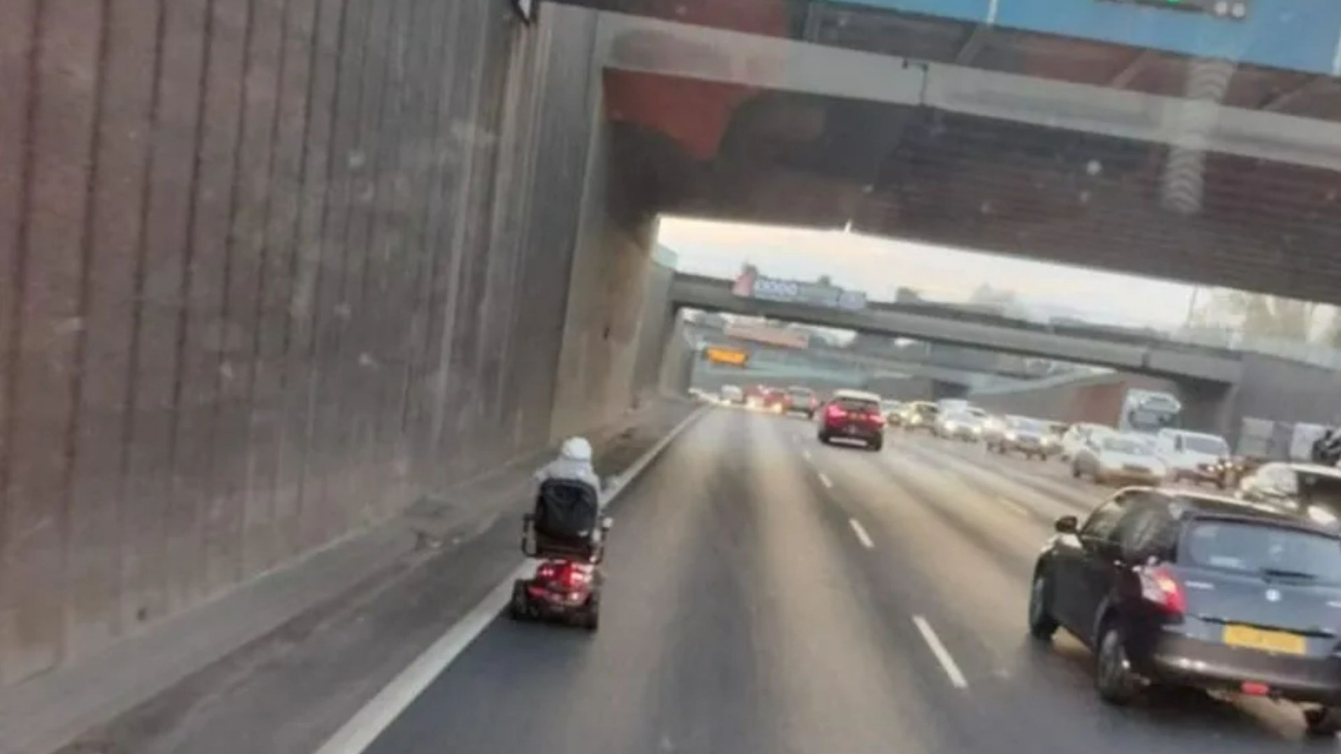 Moment pensioner speeds along 70mph road on SCOOTER during rush hour at Spaghetti Junction - leaving drivers baffled