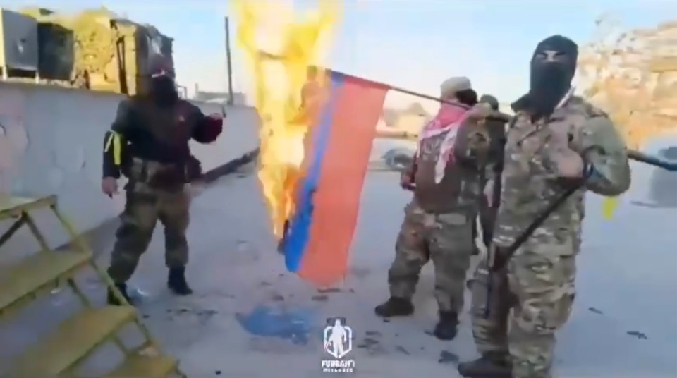 Militants also tore down and burned a Russian flag in a warning to Assad's pal Putin