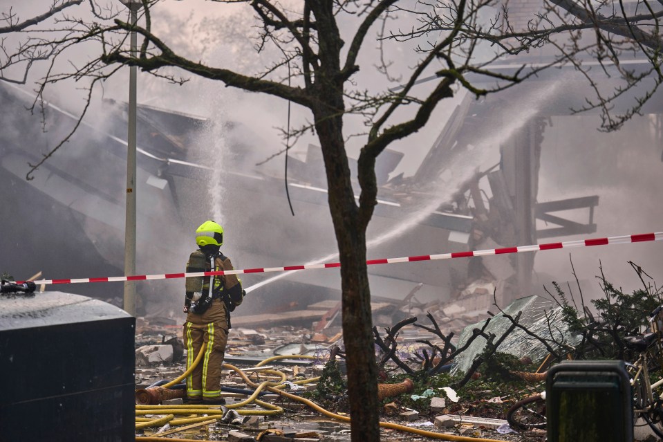 A firefighter works at the sight of an explosion