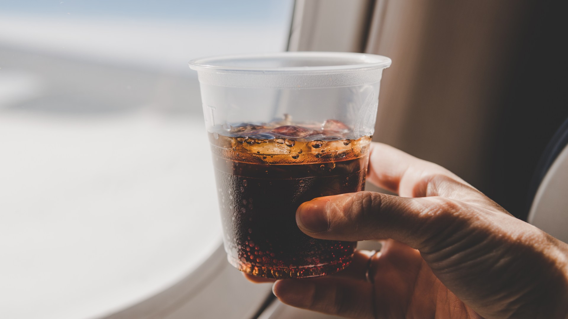 Why Coca-Cola always tastes worse on a plane and the best booze-free drink to choose instead