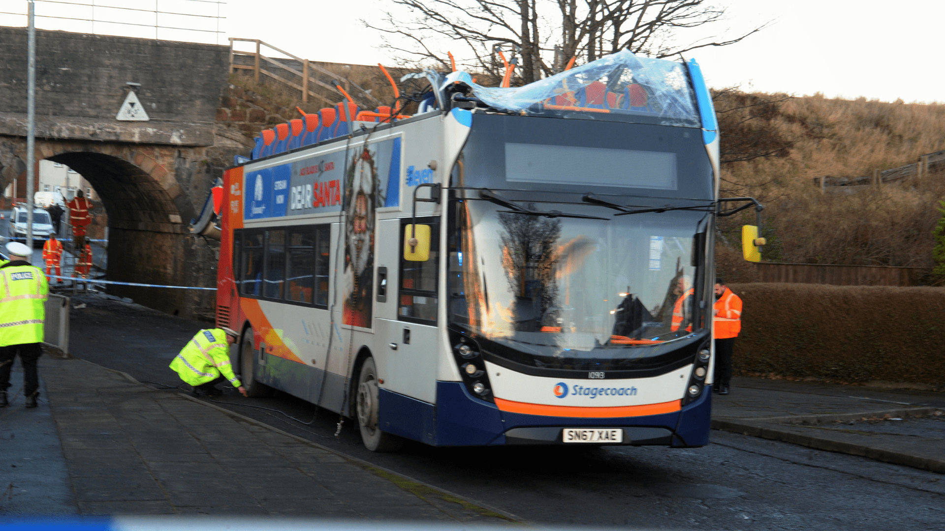 Man charged after double decker bus roof torn off in crash with bridge which left eight injured