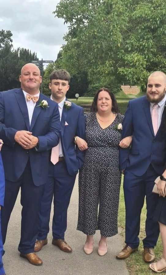 Owen between his dad and mum, with brother on the right