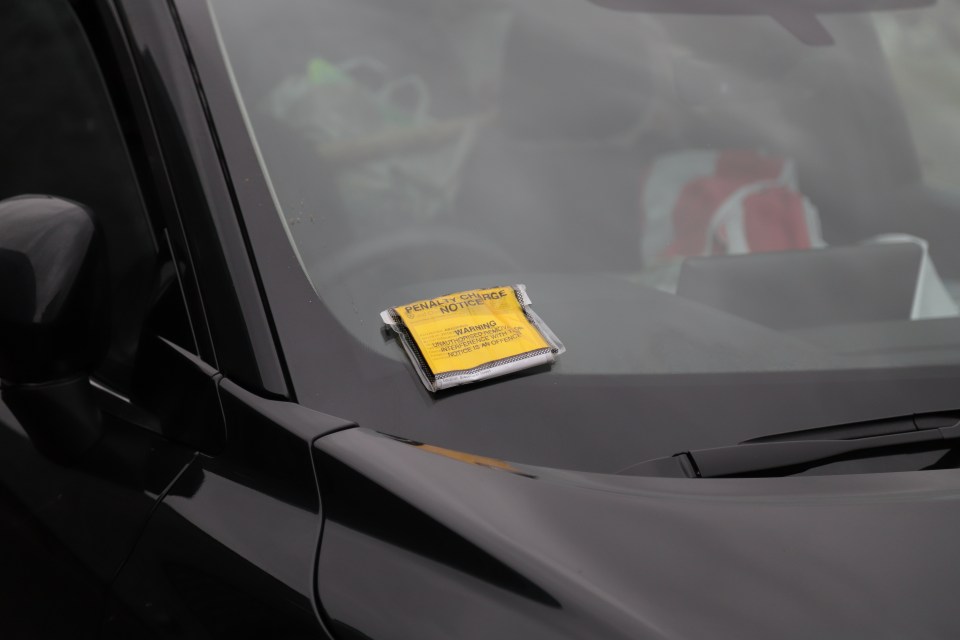 A parking ticket was seen to be placed on the windscreen of her car