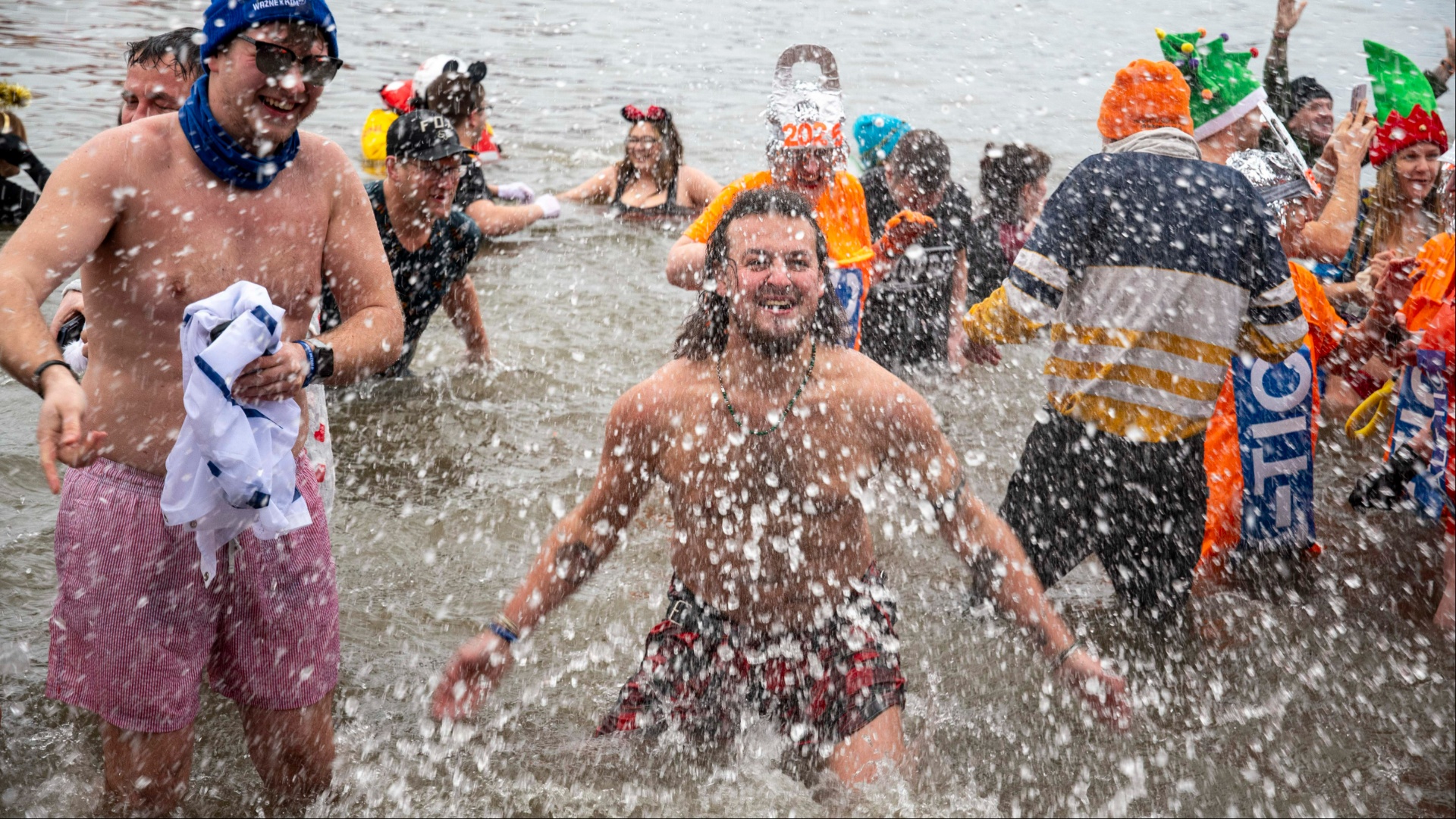 Unsuspecting Loony Dook dippers wade through raw SEWAGE pouring into the sea just yards away