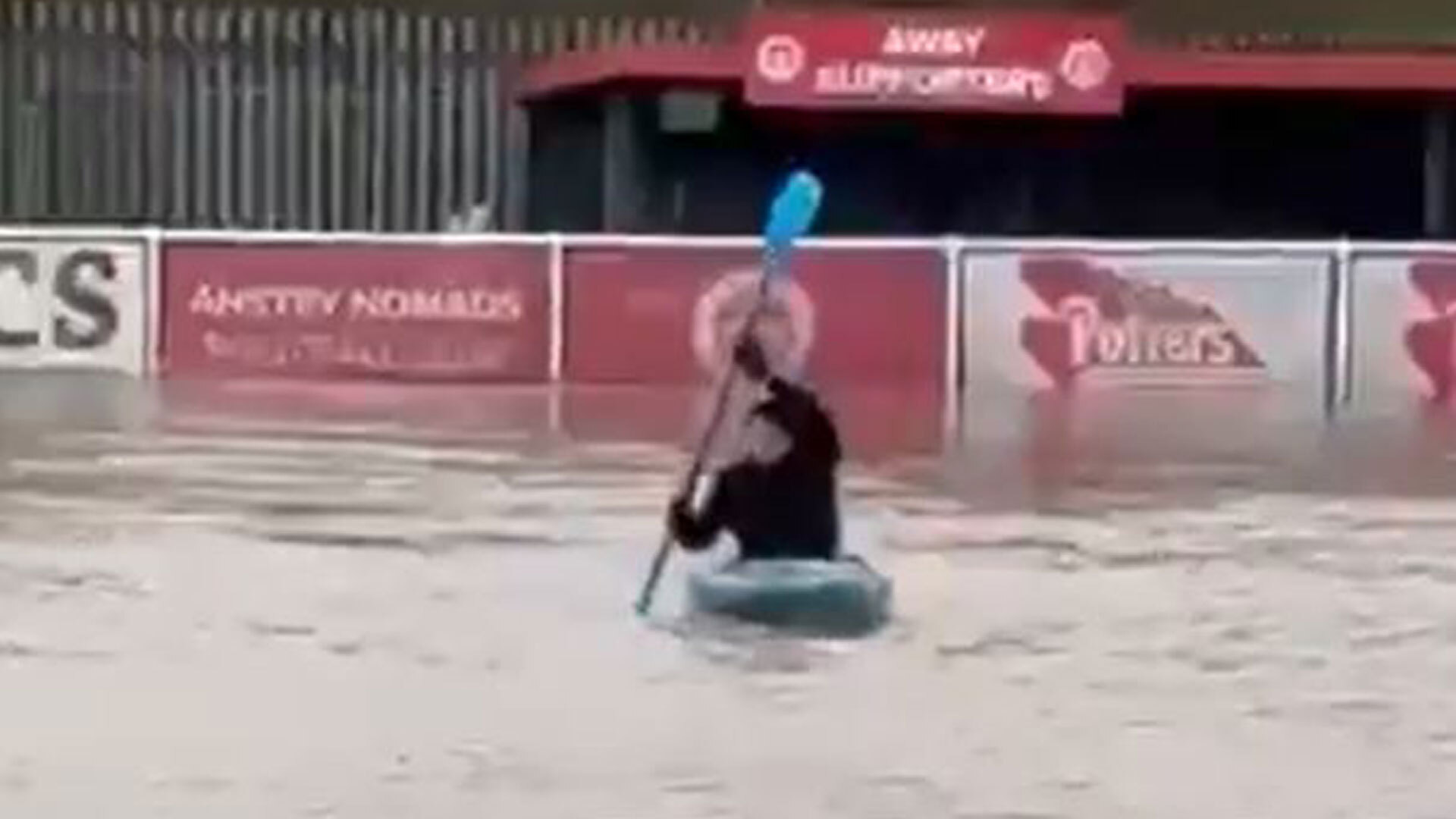 Watch bizarre moment non-league chairman KAYAKS on his club's pitch as flooding wreaks havoc again