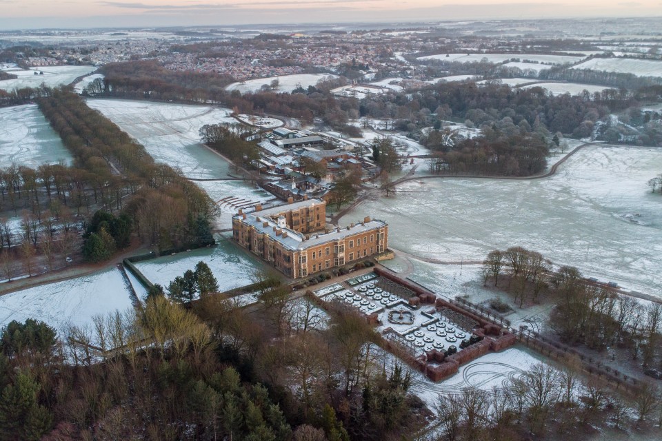 Aerial view of Temple Newsam House and its gardens covered in frost and snow.