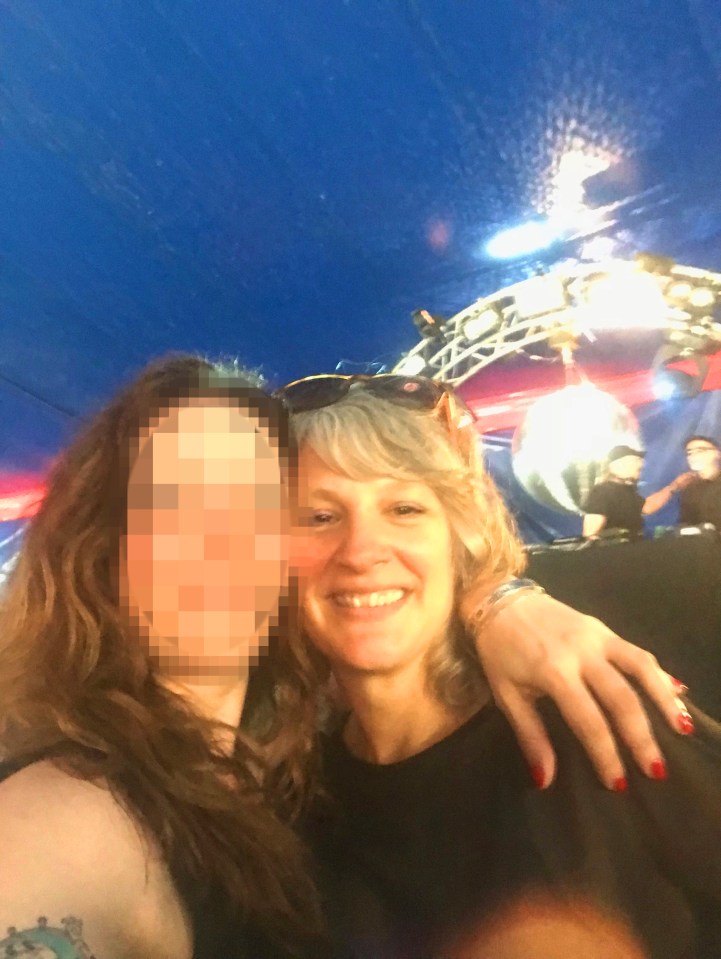 Photo of two women at a concert; one woman's face is blurred.