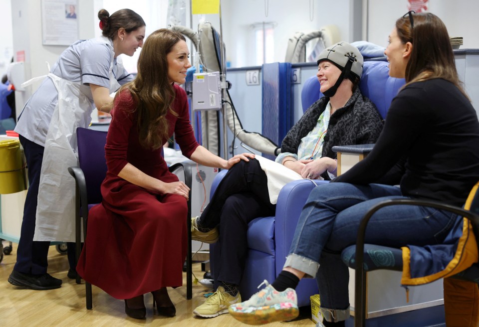 Catherine, Princess of Wales, speaks with a patient and her companion at a hospital.