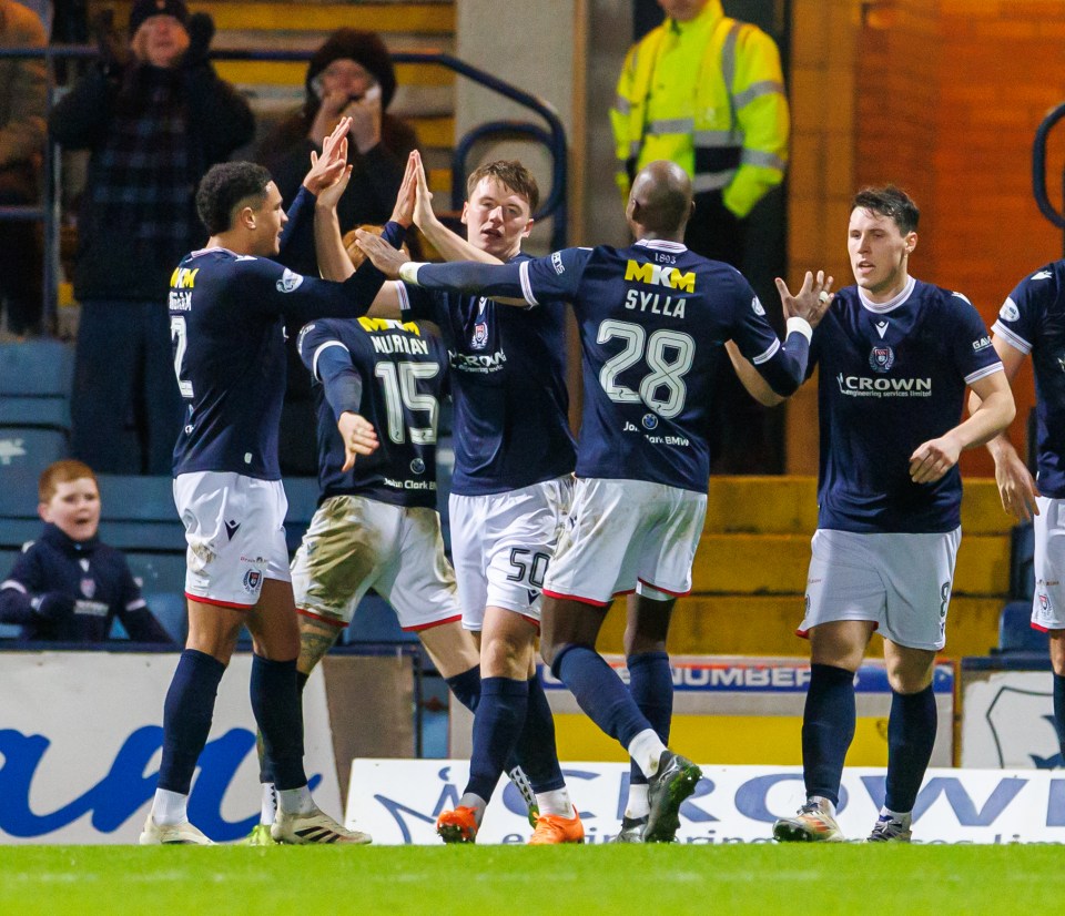 Soccer players celebrating a goal.