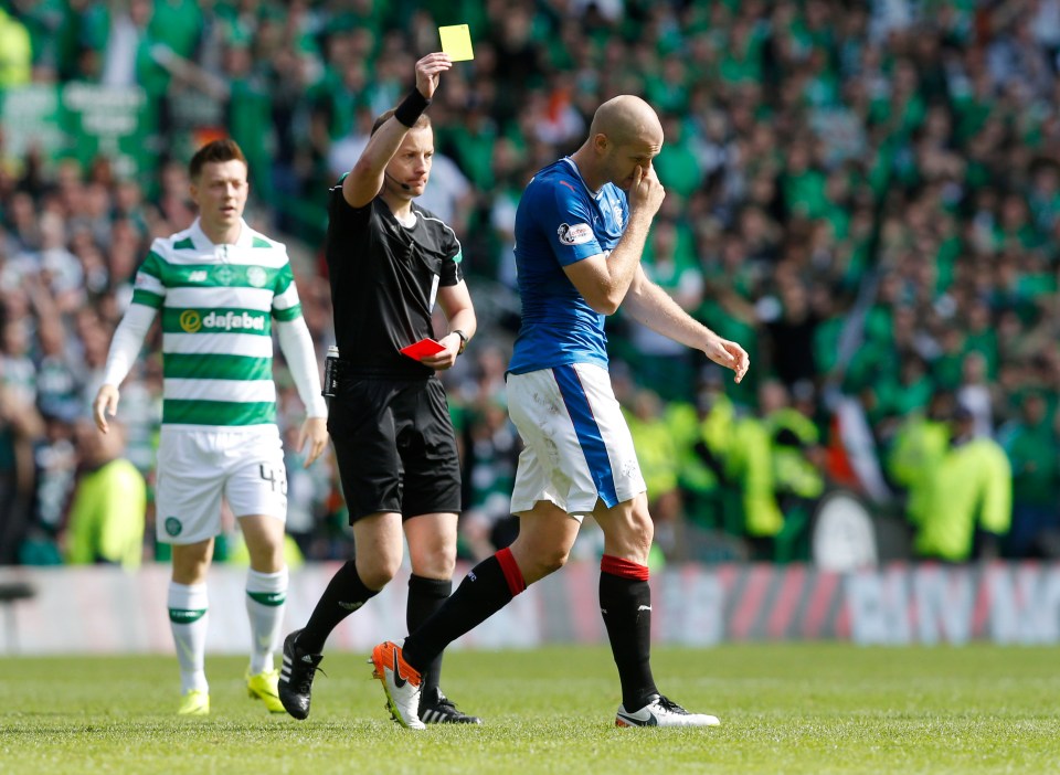 Soccer referee showing a yellow card to a player.