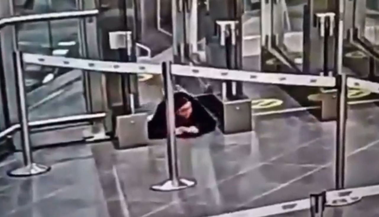 Watch moment woman crawls under airport security barrier before sneaking onto PLANE completely unnoticed