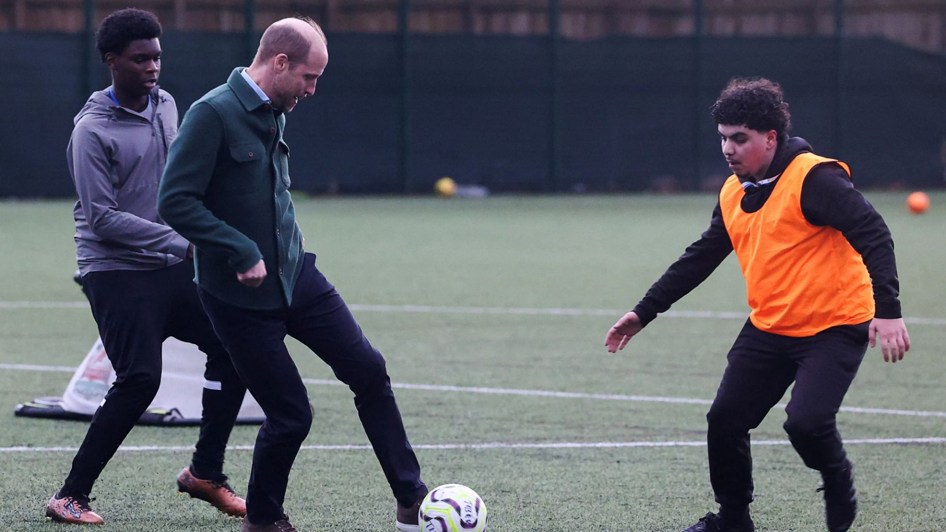 Prince William plays football with teens but barely gets a touch: 'I'm not going to go around slide tackling, am I!'