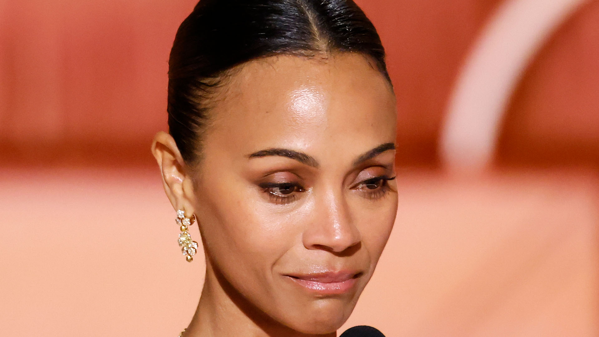 Zoe Saldana bizarrely crashes Golden Globes stage during Best Song speech as 'embarrassed' fans beg star to 'sit down'